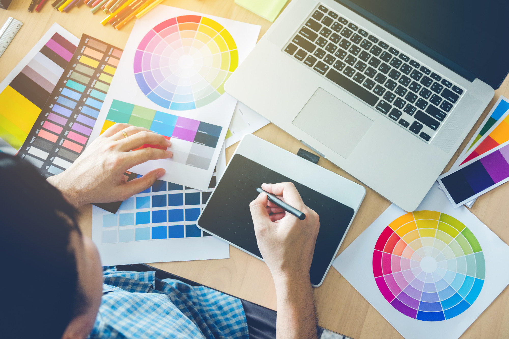 graphic designer with laptop and color wheels