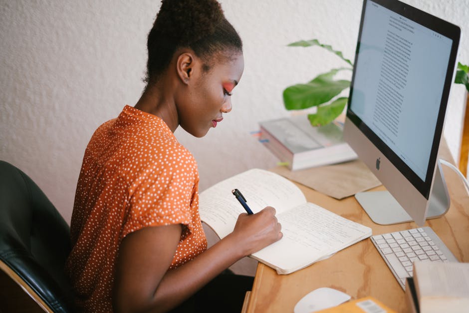 woman studying at desk with computer