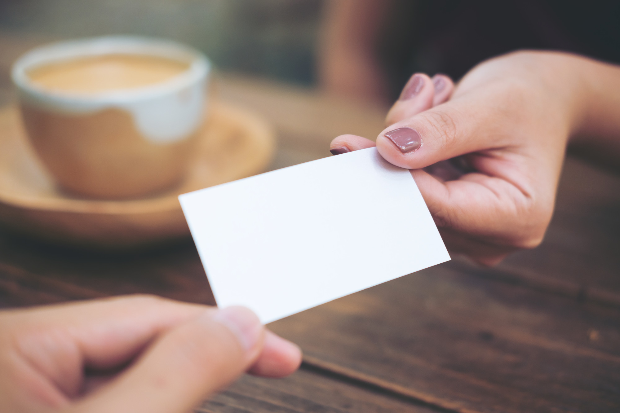 Person Handing Over a Business Card